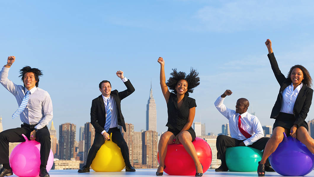 Business executives race on bouncy balls